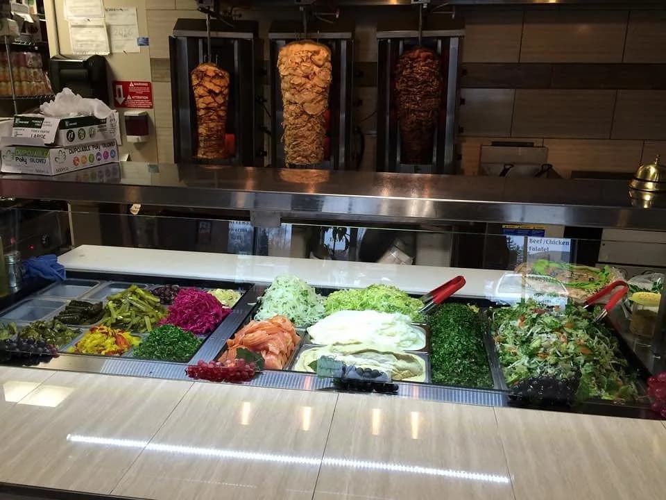 Chicken and beef shawarma spits behind the counter at Shawarma Pita Palace